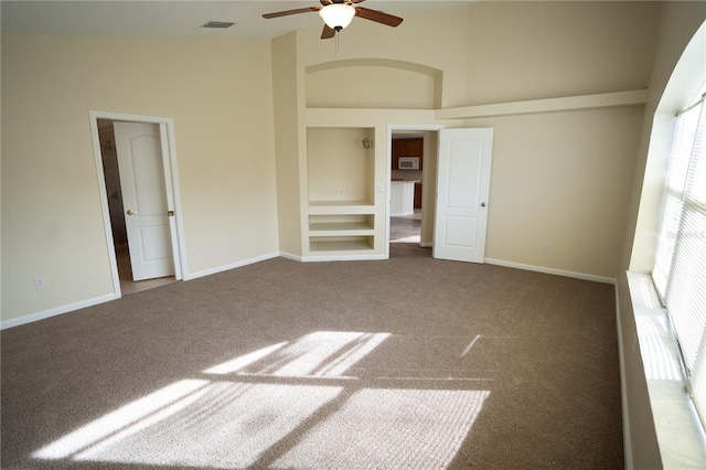 unfurnished bedroom with ceiling fan, carpet flooring, and high vaulted ceiling