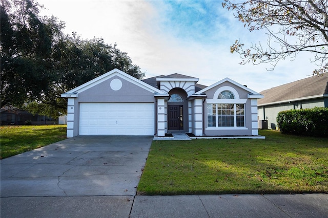 ranch-style home with central AC, a garage, and a front lawn