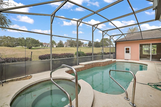 view of pool with glass enclosure and an in ground hot tub