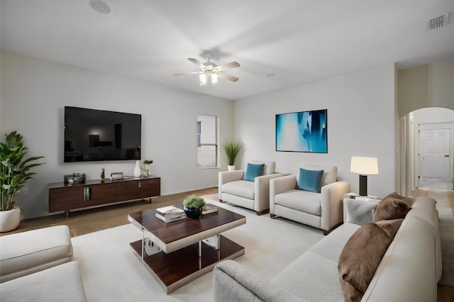 living room with light hardwood / wood-style flooring and ceiling fan