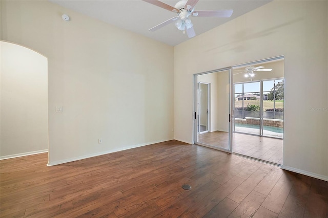 unfurnished room featuring ceiling fan and dark hardwood / wood-style flooring