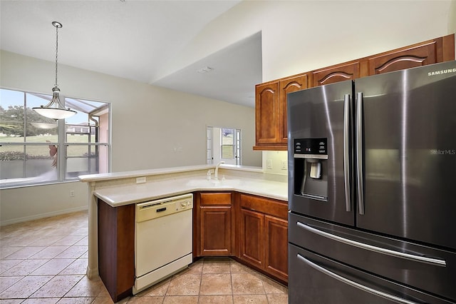 kitchen featuring kitchen peninsula, stainless steel fridge, light tile patterned floors, pendant lighting, and dishwasher