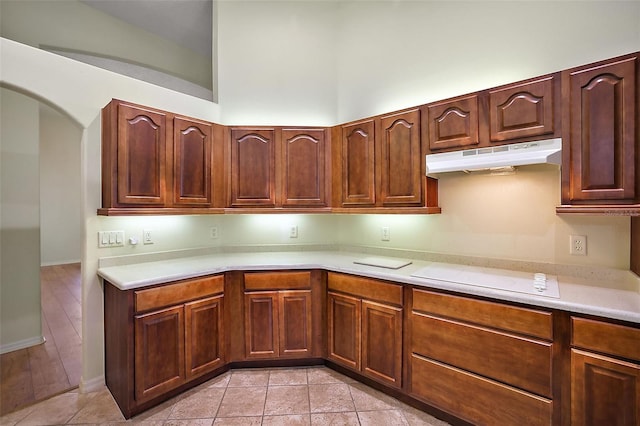 kitchen featuring light tile patterned floors and white electric stovetop