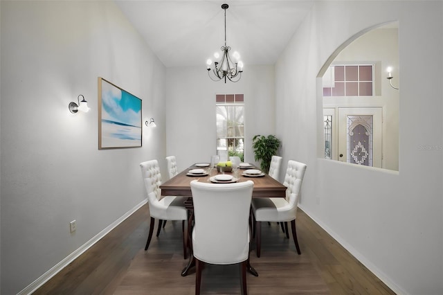 dining space with a chandelier and dark hardwood / wood-style floors