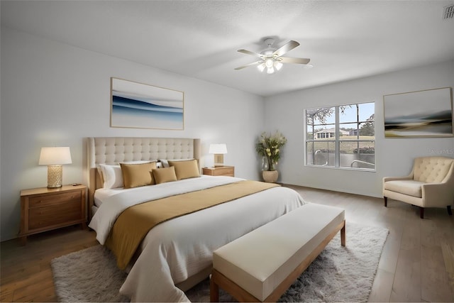 bedroom with hardwood / wood-style floors and ceiling fan