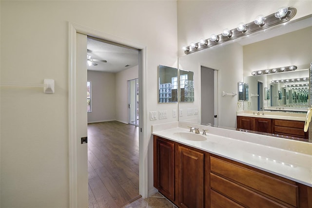 bathroom with ceiling fan, vanity, and hardwood / wood-style flooring