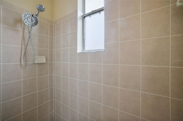 bathroom with tiled shower