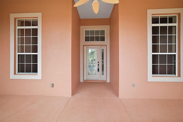 entrance to property featuring ceiling fan