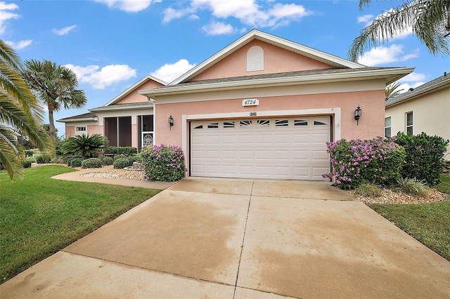 view of front facade with a front yard and a garage