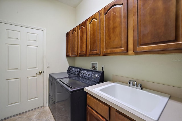 laundry area featuring cabinets, light tile patterned floors, washer and dryer, and sink