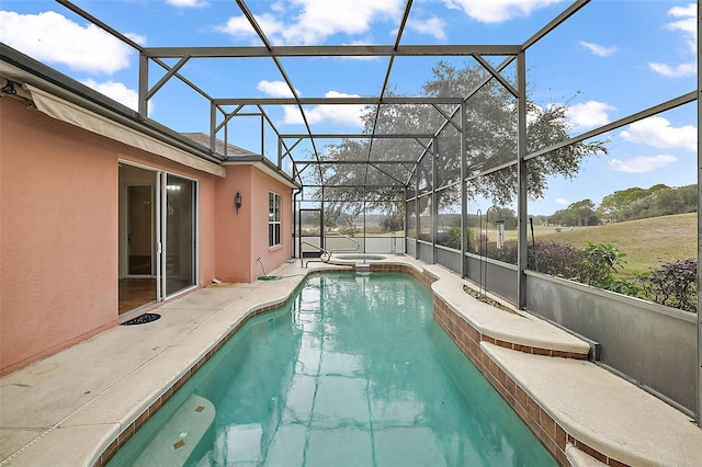 view of swimming pool featuring a lanai, a patio area, and an in ground hot tub