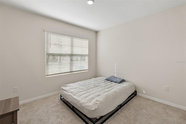 bedroom featuring light carpet