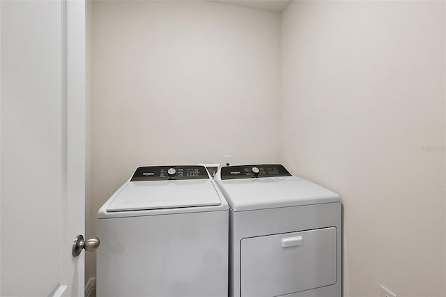 clothes washing area with washing machine and clothes dryer