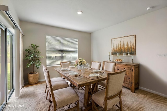 dining space featuring light colored carpet