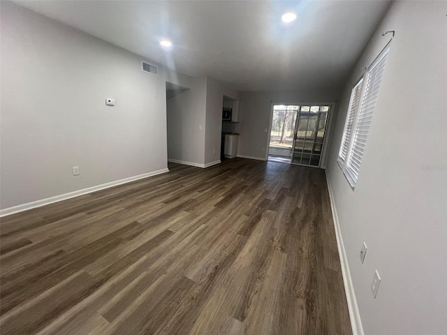 empty room featuring dark hardwood / wood-style flooring