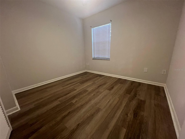 spare room with dark hardwood / wood-style floors