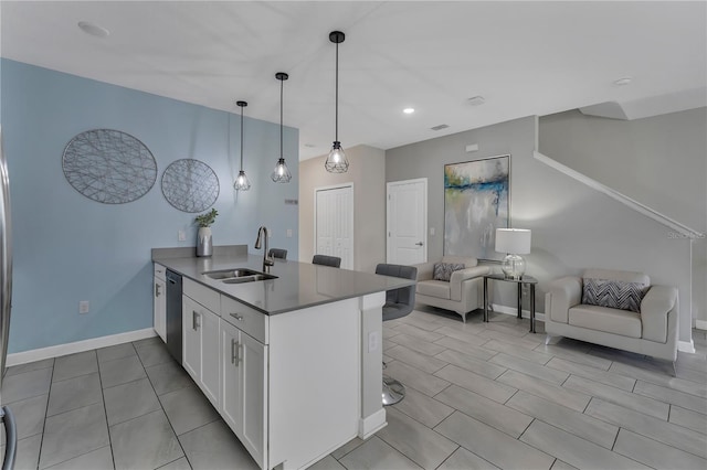 kitchen featuring white cabinetry, sink, dishwasher, kitchen peninsula, and pendant lighting