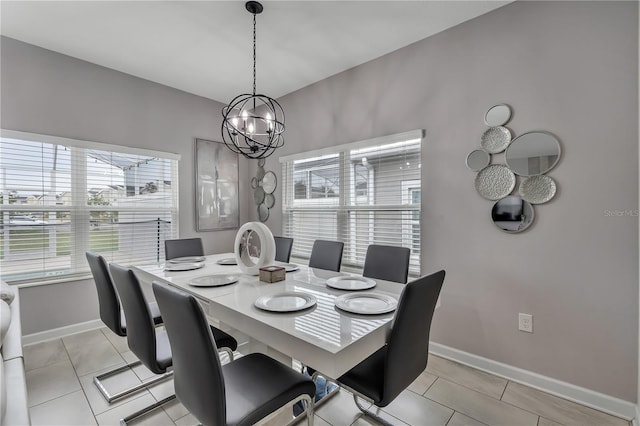 dining area with a chandelier and light tile patterned flooring