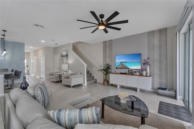 tiled living room featuring ceiling fan