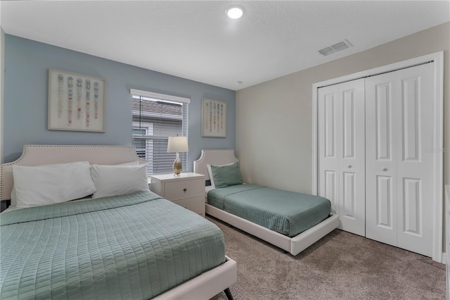 bedroom featuring light carpet and a closet