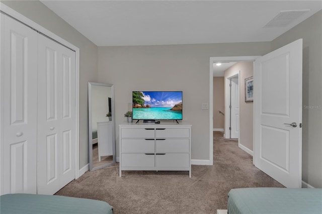 carpeted bedroom with a closet