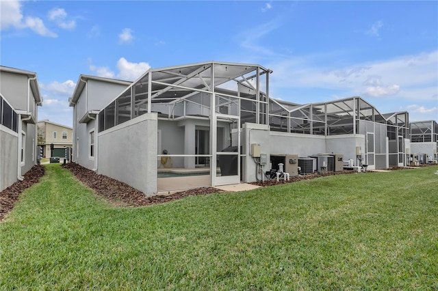 back of house featuring a lawn, central AC, and a lanai