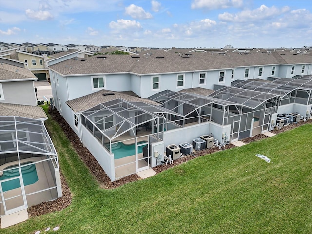 back of property featuring central AC unit and a lanai