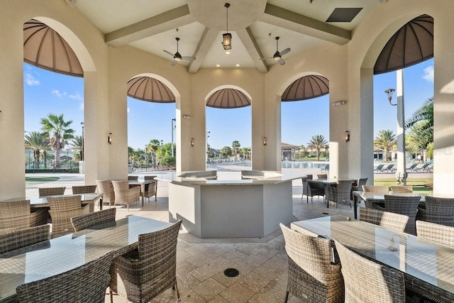 view of patio / terrace with an outdoor bar and ceiling fan