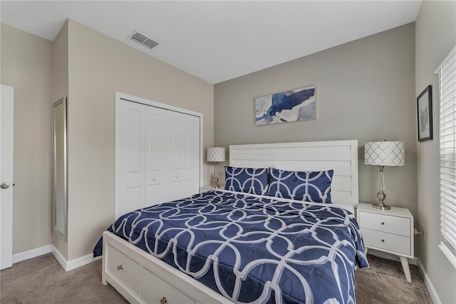 bedroom with a closet, carpet floors, and multiple windows