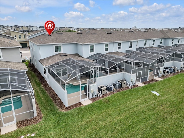 back of property with central AC unit and glass enclosure