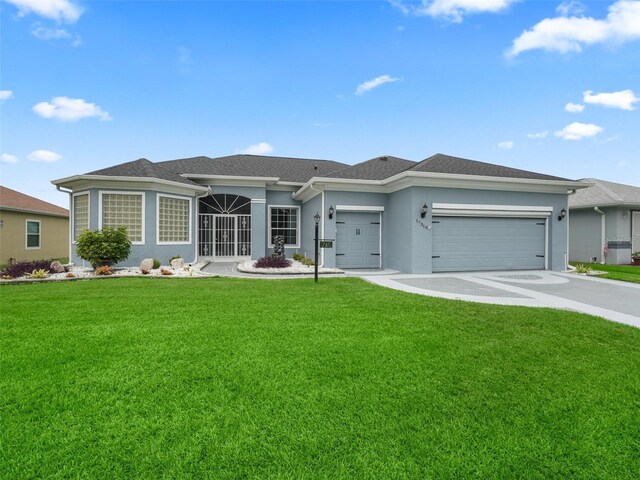 single story home featuring a front yard and a garage