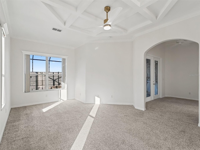 empty room featuring carpet flooring, ceiling fan, french doors, coffered ceiling, and beamed ceiling