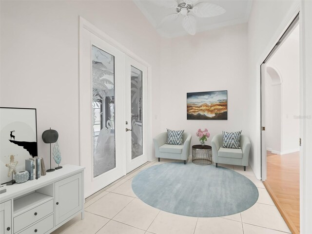 living area with ceiling fan, light wood-type flooring, and french doors