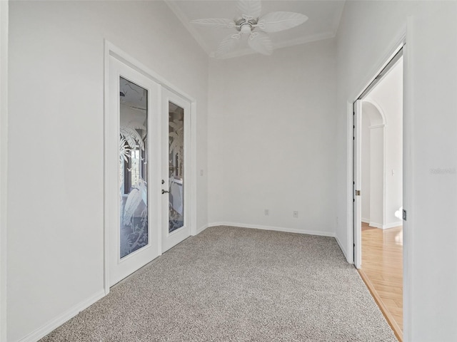 unfurnished room featuring light carpet, french doors, and ceiling fan