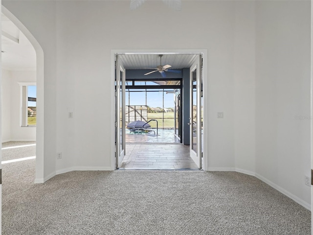 entryway featuring carpet, ceiling fan, and wooden ceiling