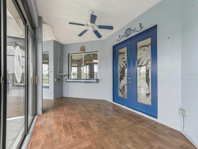 interior space with ceiling fan, wood-type flooring, and french doors