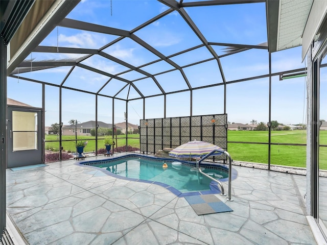 view of swimming pool featuring a lawn, a lanai, and a patio