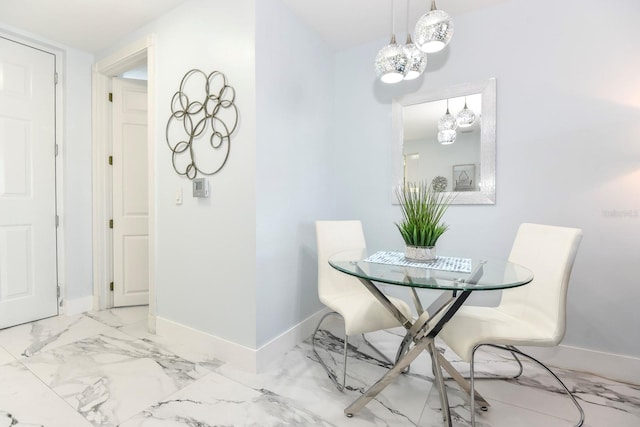 dining room featuring light tile flooring and a notable chandelier