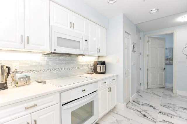 kitchen with white appliances, white cabinetry, tasteful backsplash, and light tile flooring