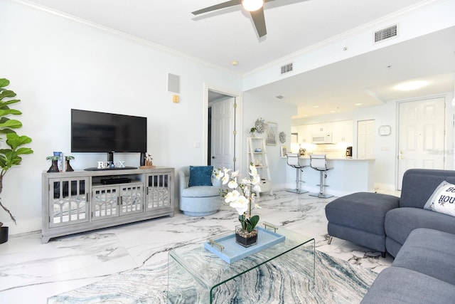 tiled living room with ornamental molding and ceiling fan