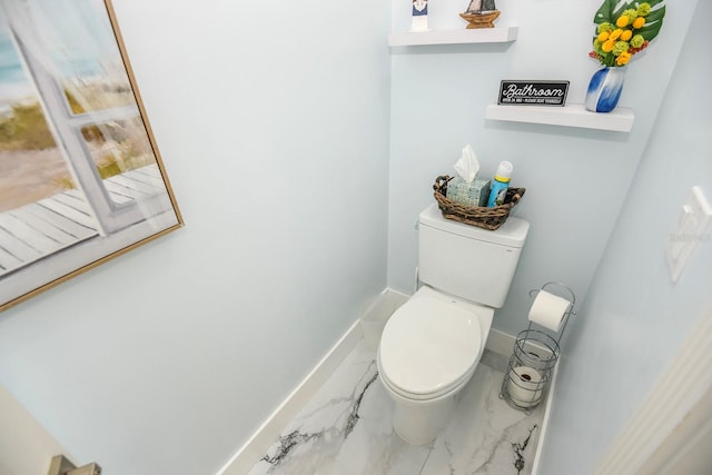 bathroom with toilet and tile floors