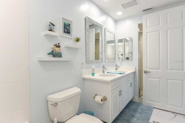 bathroom with toilet, tile flooring, a shower with shower door, and vanity