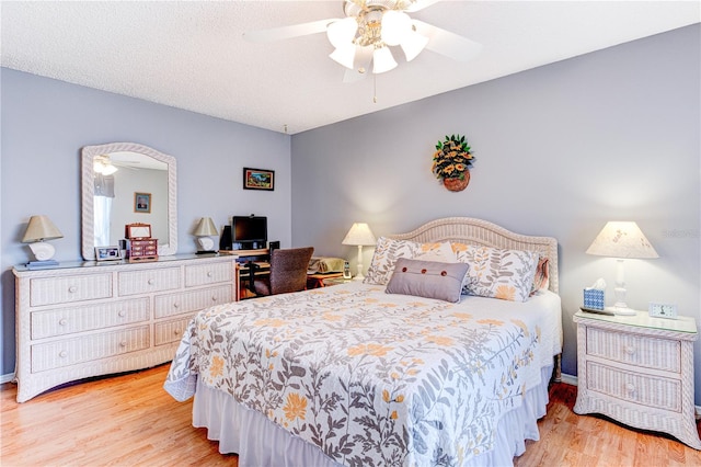 bedroom with ceiling fan and light hardwood / wood-style flooring