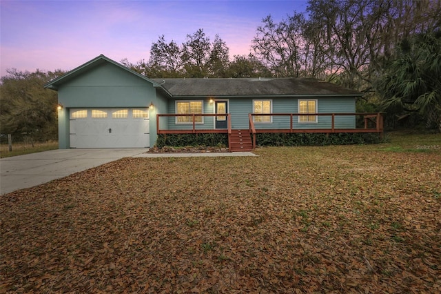 ranch-style house featuring a garage and a yard