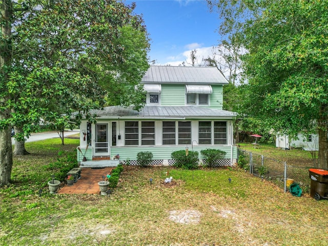 rear view of property with a yard