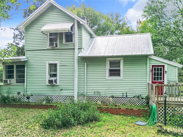 view of home's exterior featuring a wooden deck