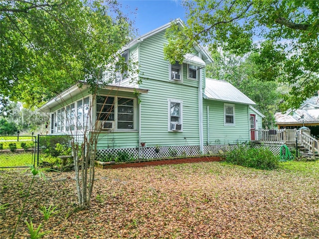 view of home's exterior featuring a wooden deck