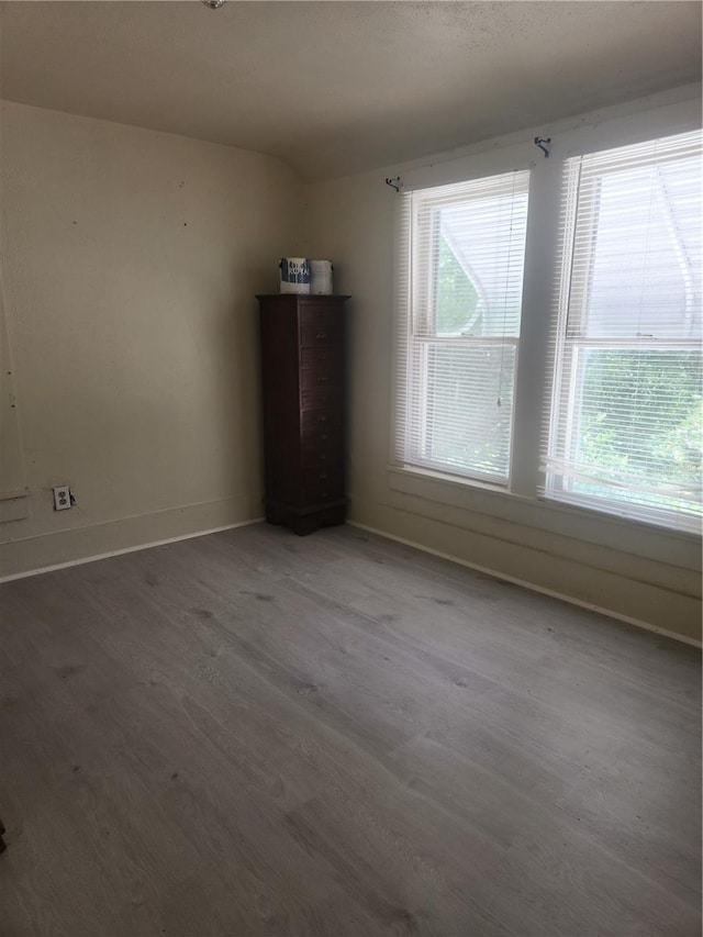 unfurnished room with hardwood / wood-style floors