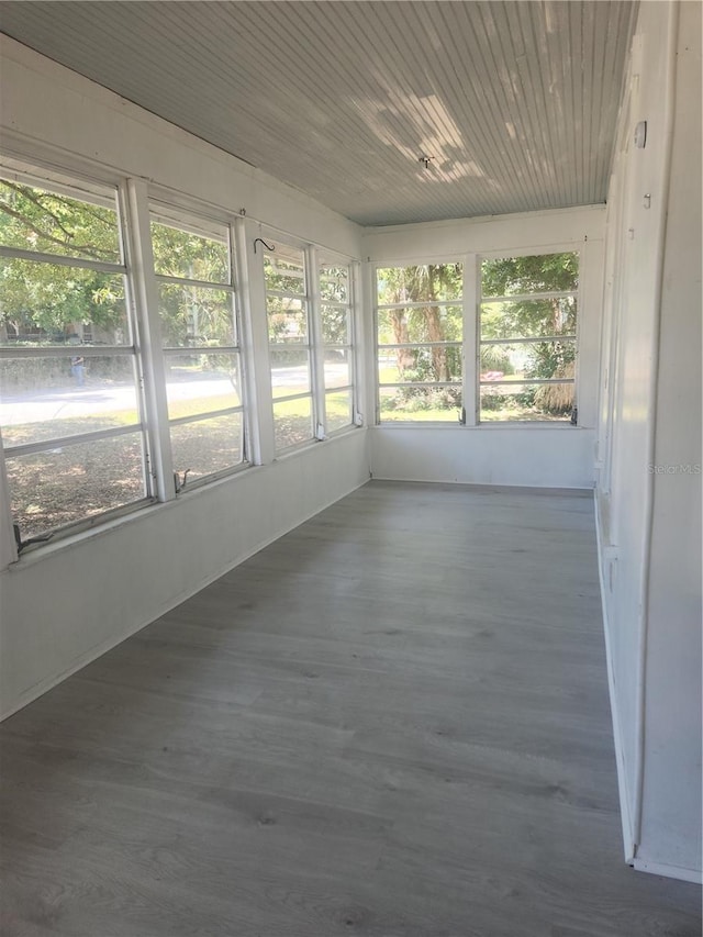 unfurnished sunroom with wooden ceiling