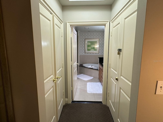 hallway with light colored carpet